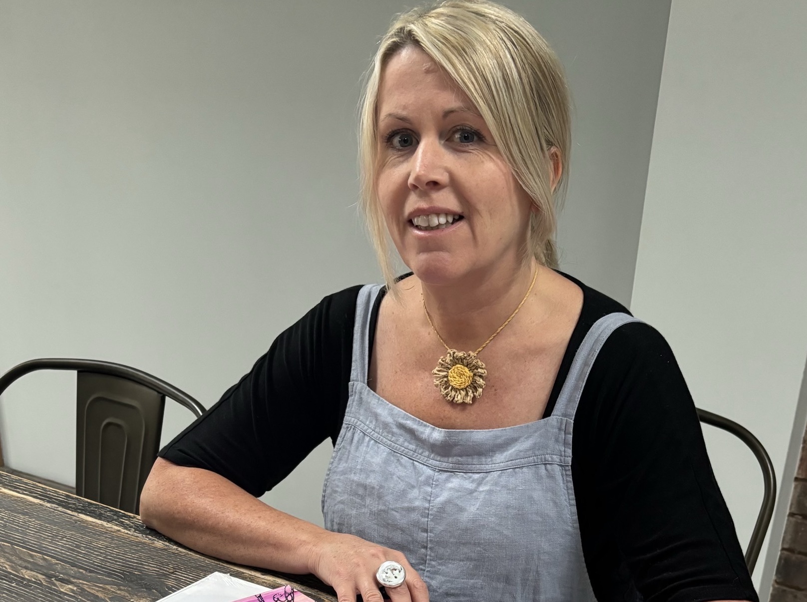 A flock of pigeons in flight, silhouetted against a blue sky with clouds